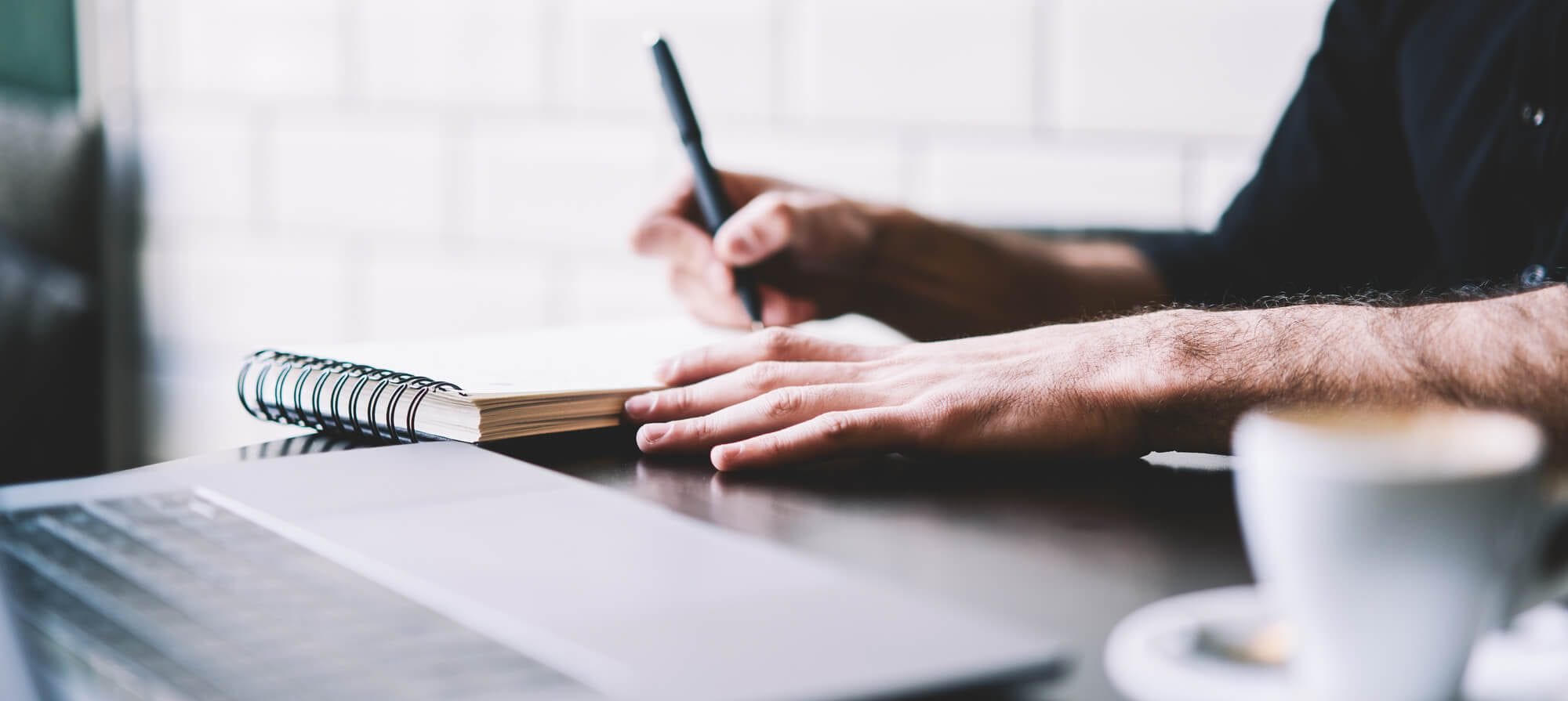 Man Writing with Pen and Paper